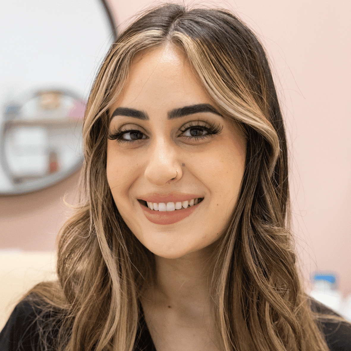 Portrait of Dalida, a professional stylist at Salon Blissful Med Spa, showcasing their expertise and style.